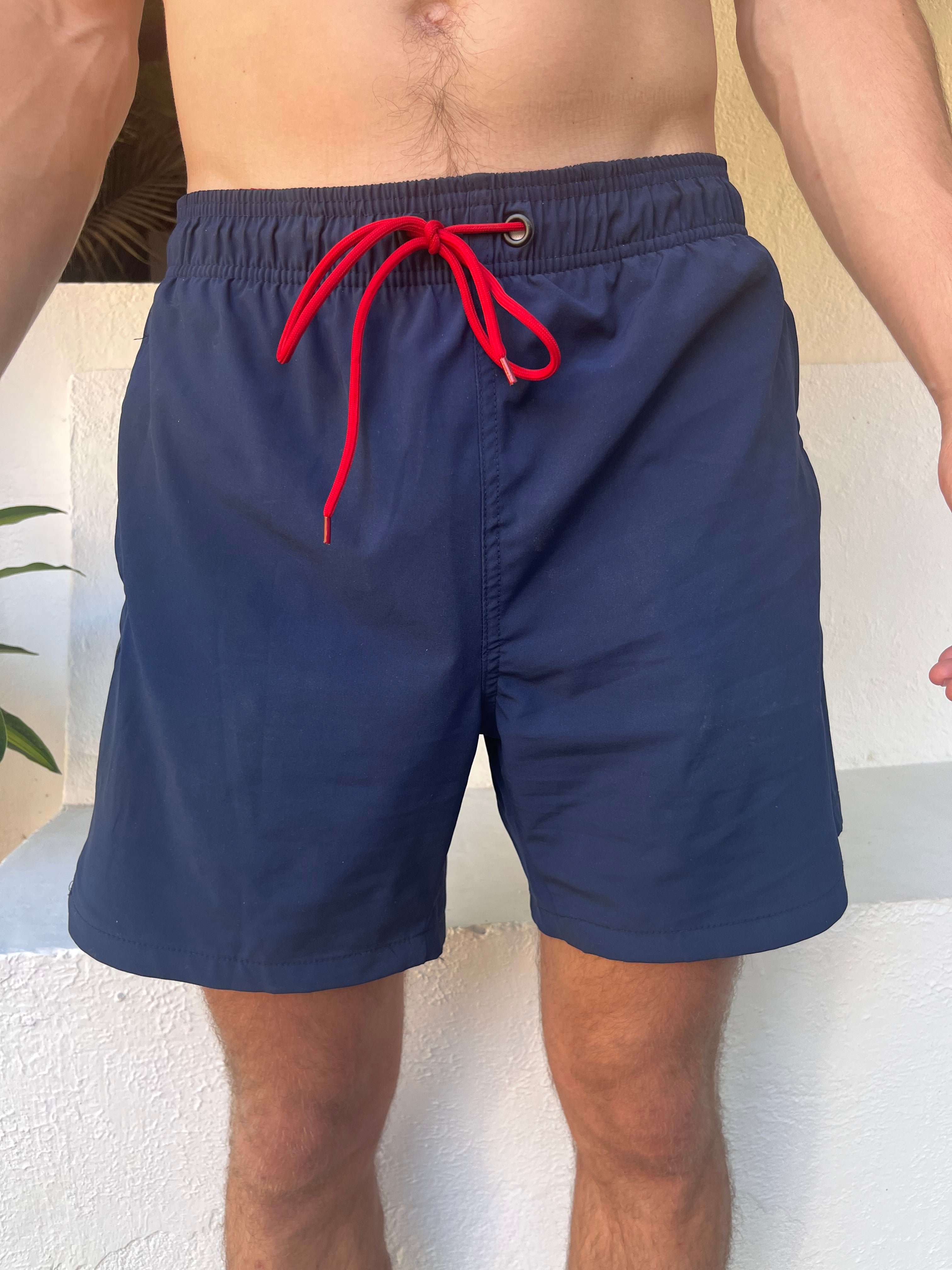 Front side Loa  navy blue swimming shorts. Zipped pockets. 