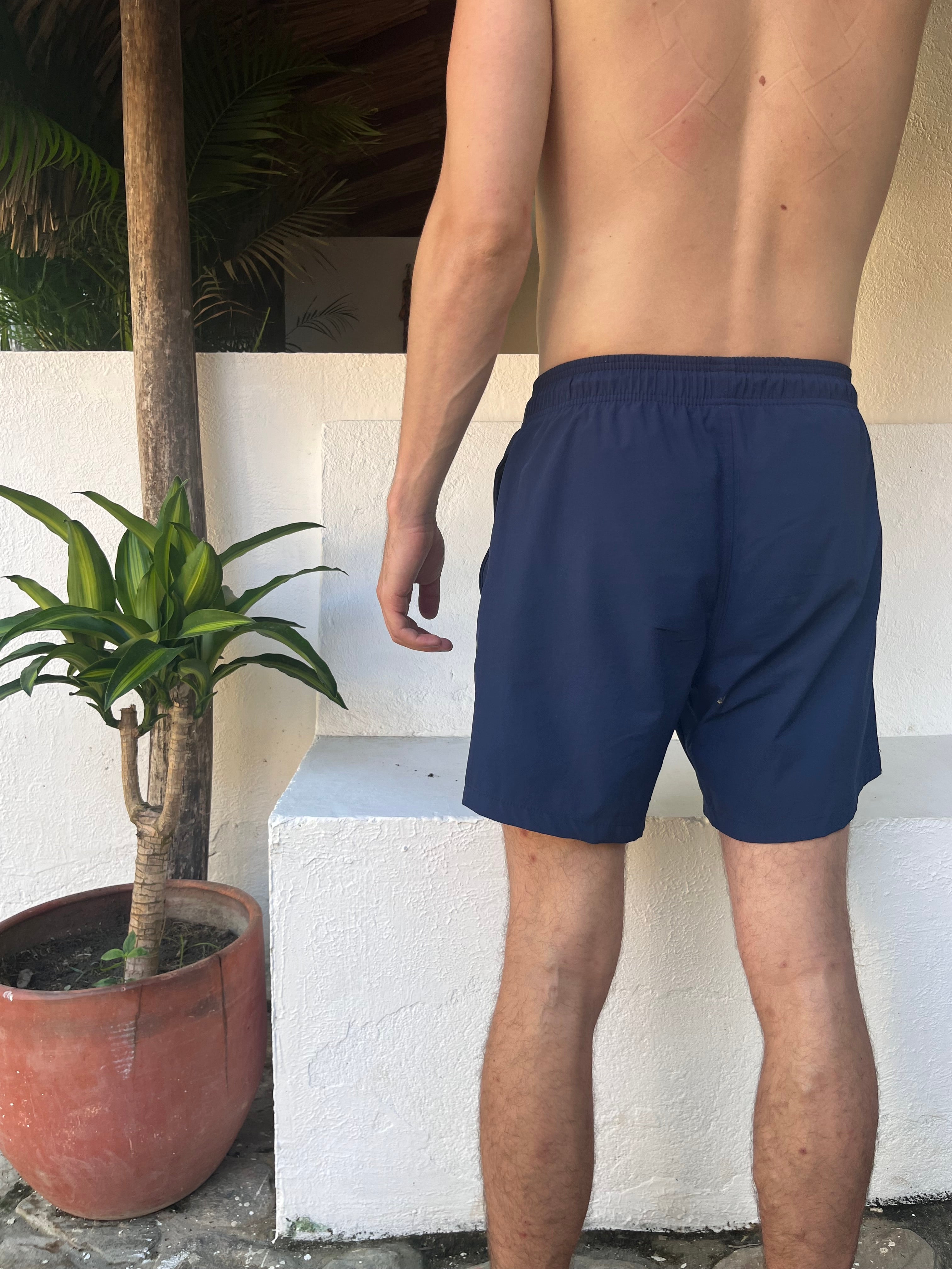 Backside Loa navy blue swimming shorts. Zipped pockets.