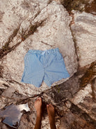 Swimming shorts with blue stripes. Shorts include zipped pockets. Shorts from Loa. 