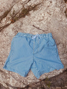 Swimming shorts with blue stripes. The shorts have zipped pockets. From Loa swimwear.