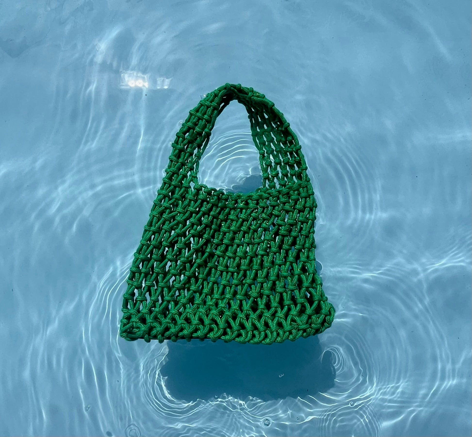 The crotched green bag of Loa in the pool. 
