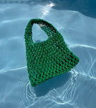 The crotched green bag in the pool. Loa. 