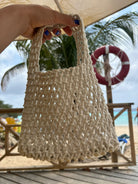 Small white Crocheted bag of the Loa brand